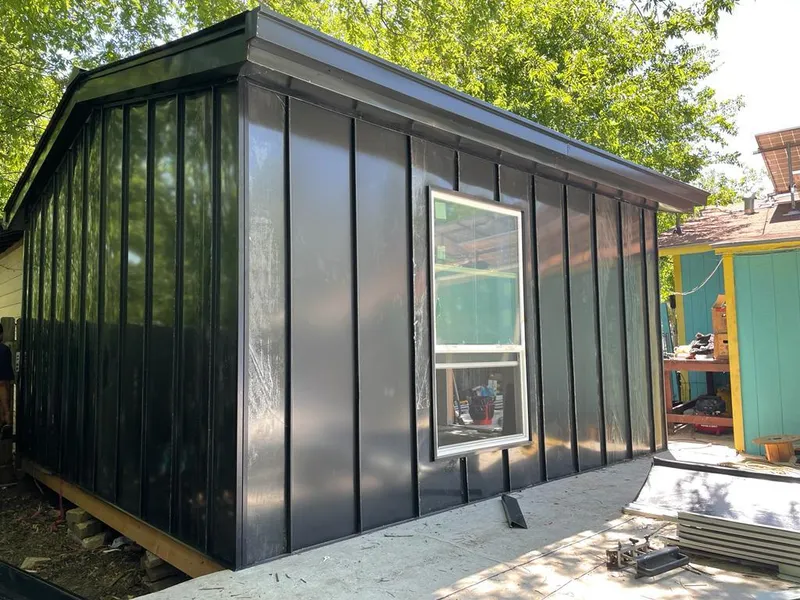 Black standing seam metal wall panels for Roof Inspection in Hanson